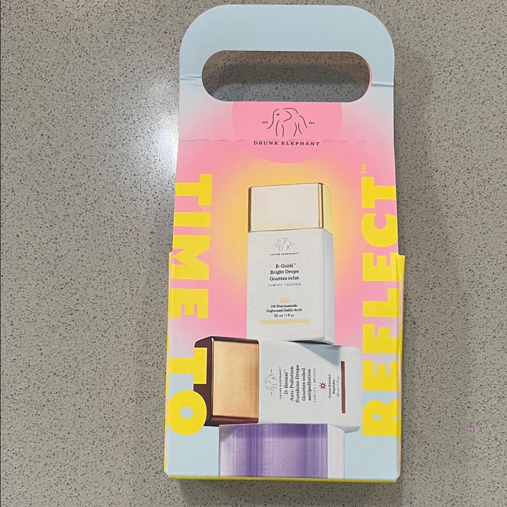 Drunk Elephant Time to Reflect Set with Gold, White, and Purple